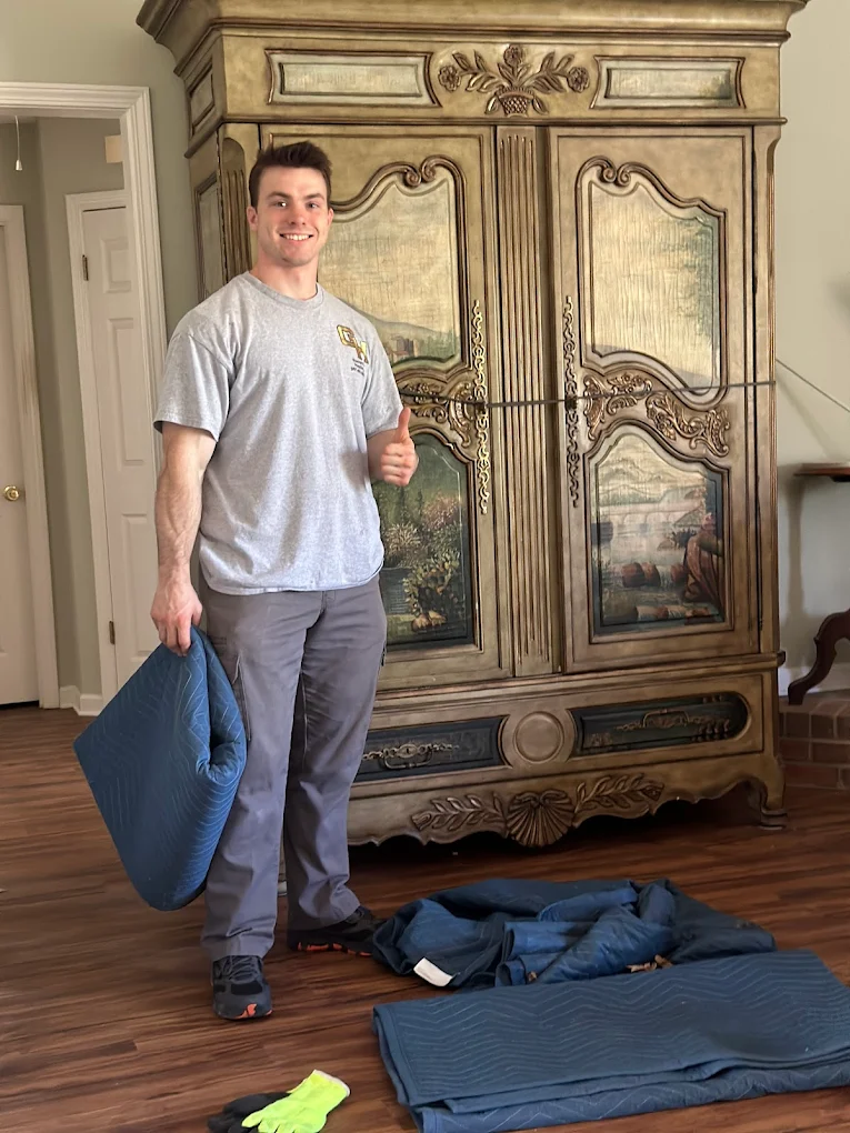 Garrett, mid-job, behind a 9-foot French armoire.