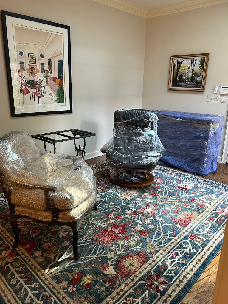 Antique chairs shrink-wrapped over a Persian rug — without a single shift.